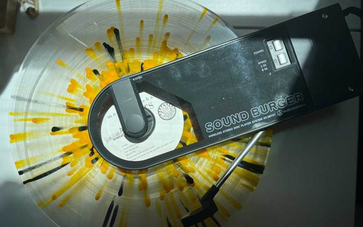  A yellow and black clear splatter record inserted into a black Audio-Technica Sound Burger