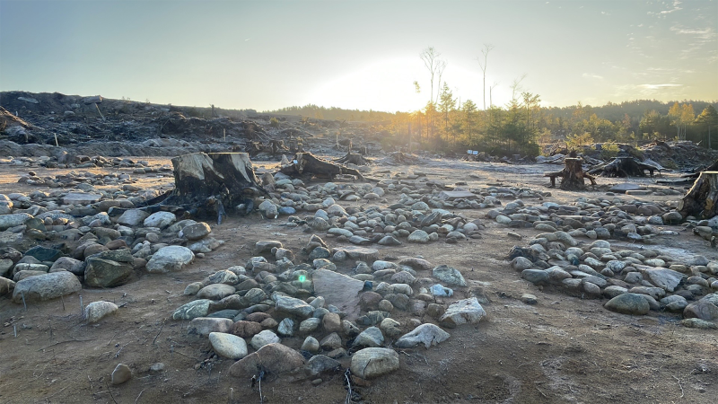 several stone circles marking gravesites in a field in norway