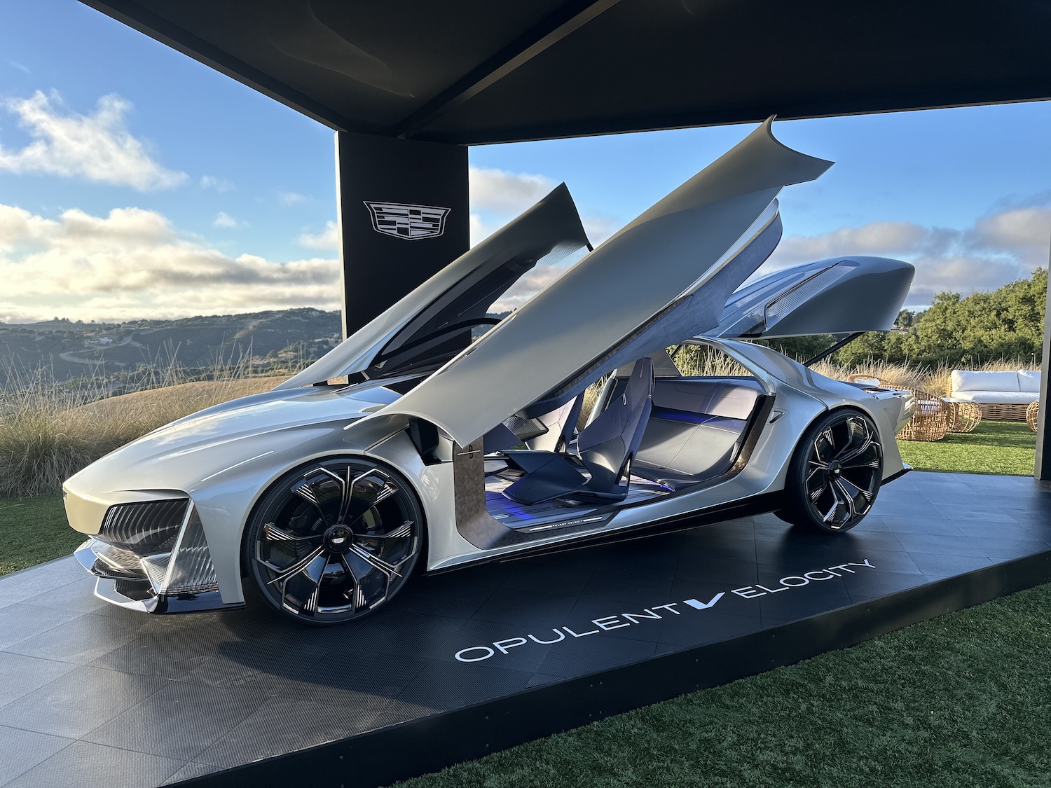 a sports car with its door and trunk open on a platform