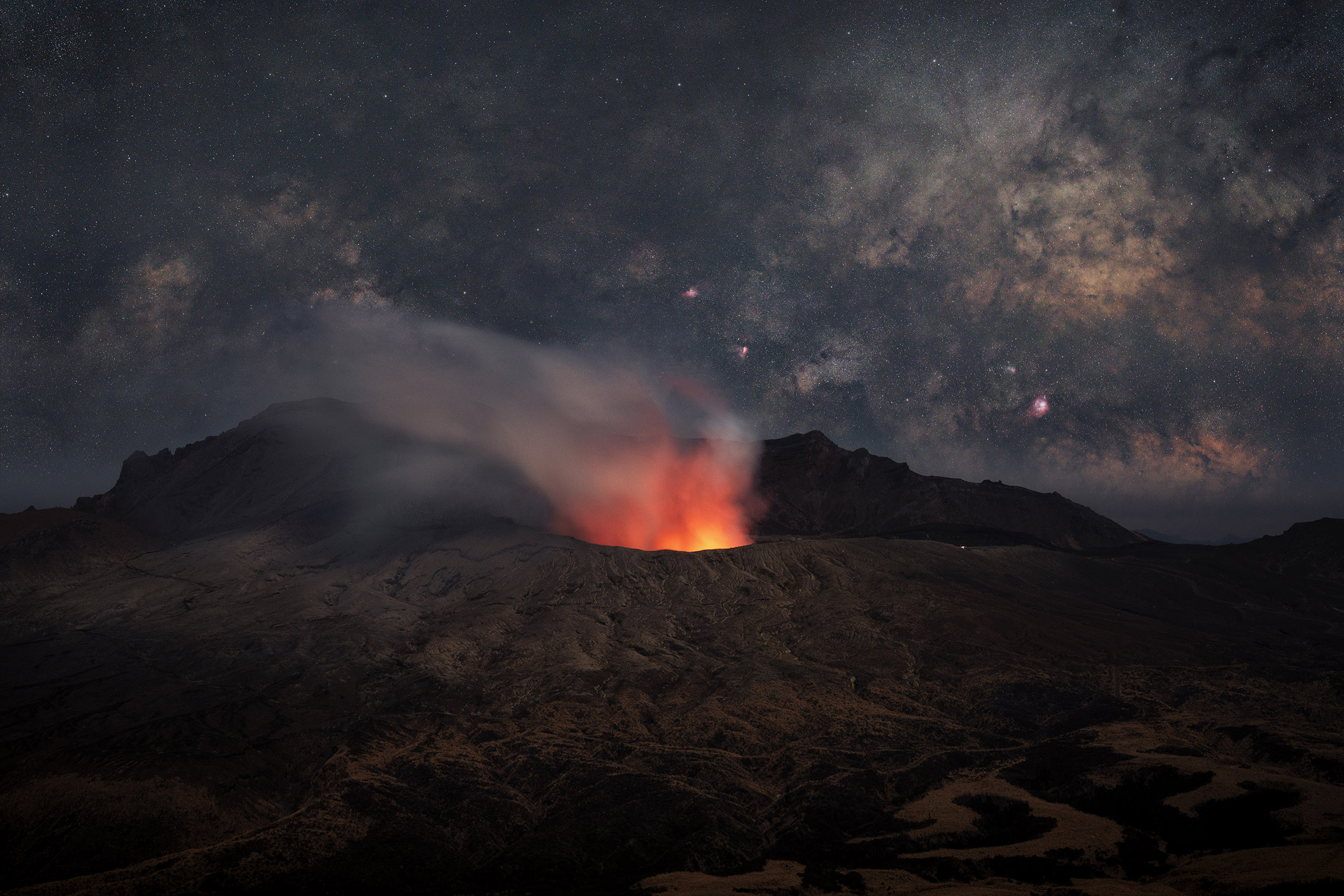 volcanic fire originates in the foreground with stars and skies in the background