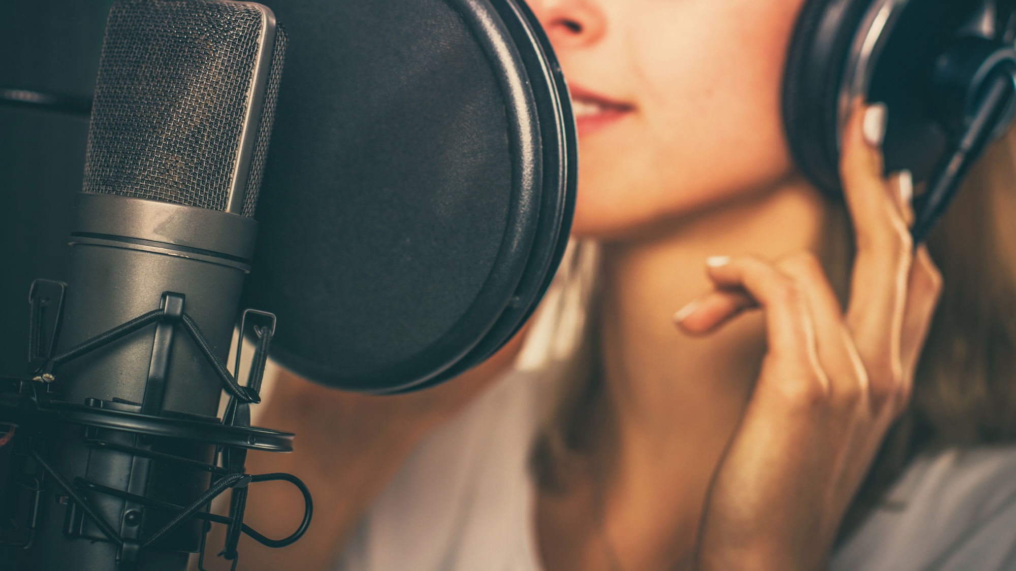 Woman singing in studio microphone