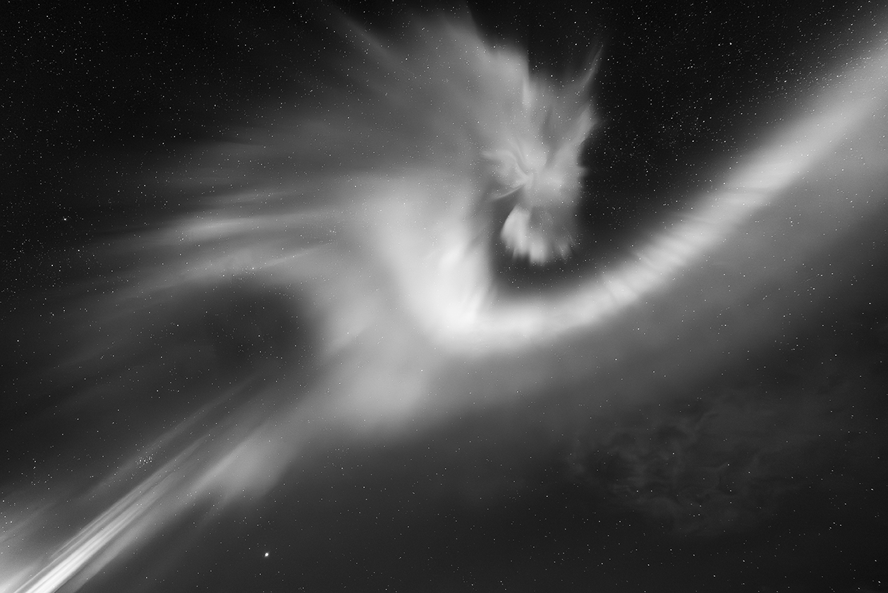 a swirling aurora resembling a dragon's head turning back