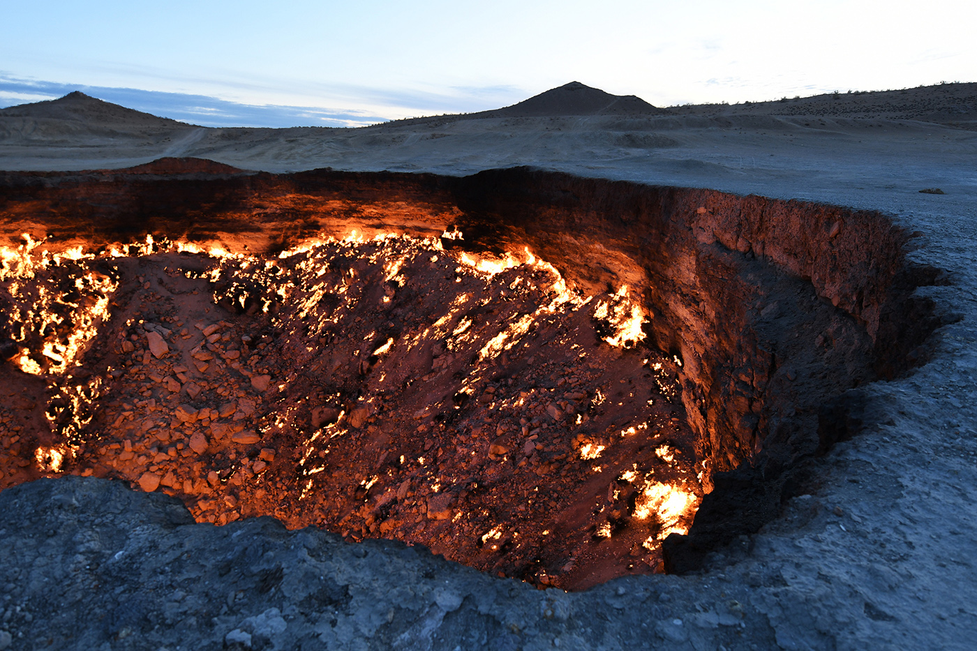 The Darvaza Gas Crater is actually man-made: in the 1970s, Soviet engineers were doing gas explorations in the area, and made a whole mass of land sink in to reveal Darvaza. They subsequently set the sinkhole on fire - it has been burning to this day and remains a major tourist attraction.