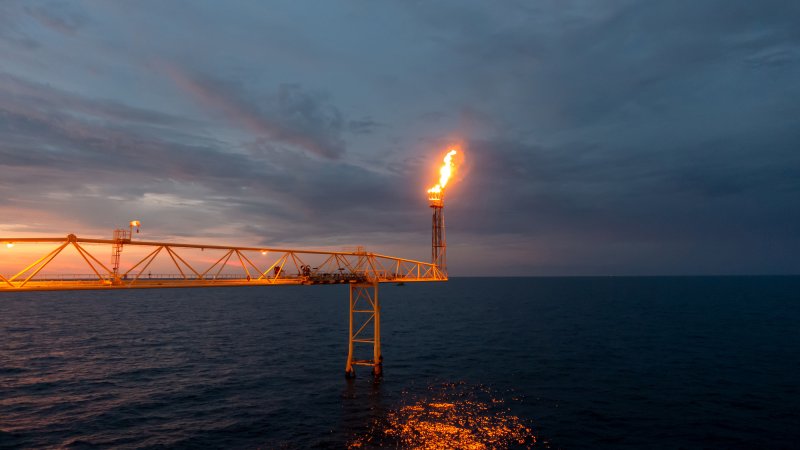 An oil rig flares methane, the main component of natural gas. When operators do not have capacity to transport natural gas, it is often burned off into the atmosphere.