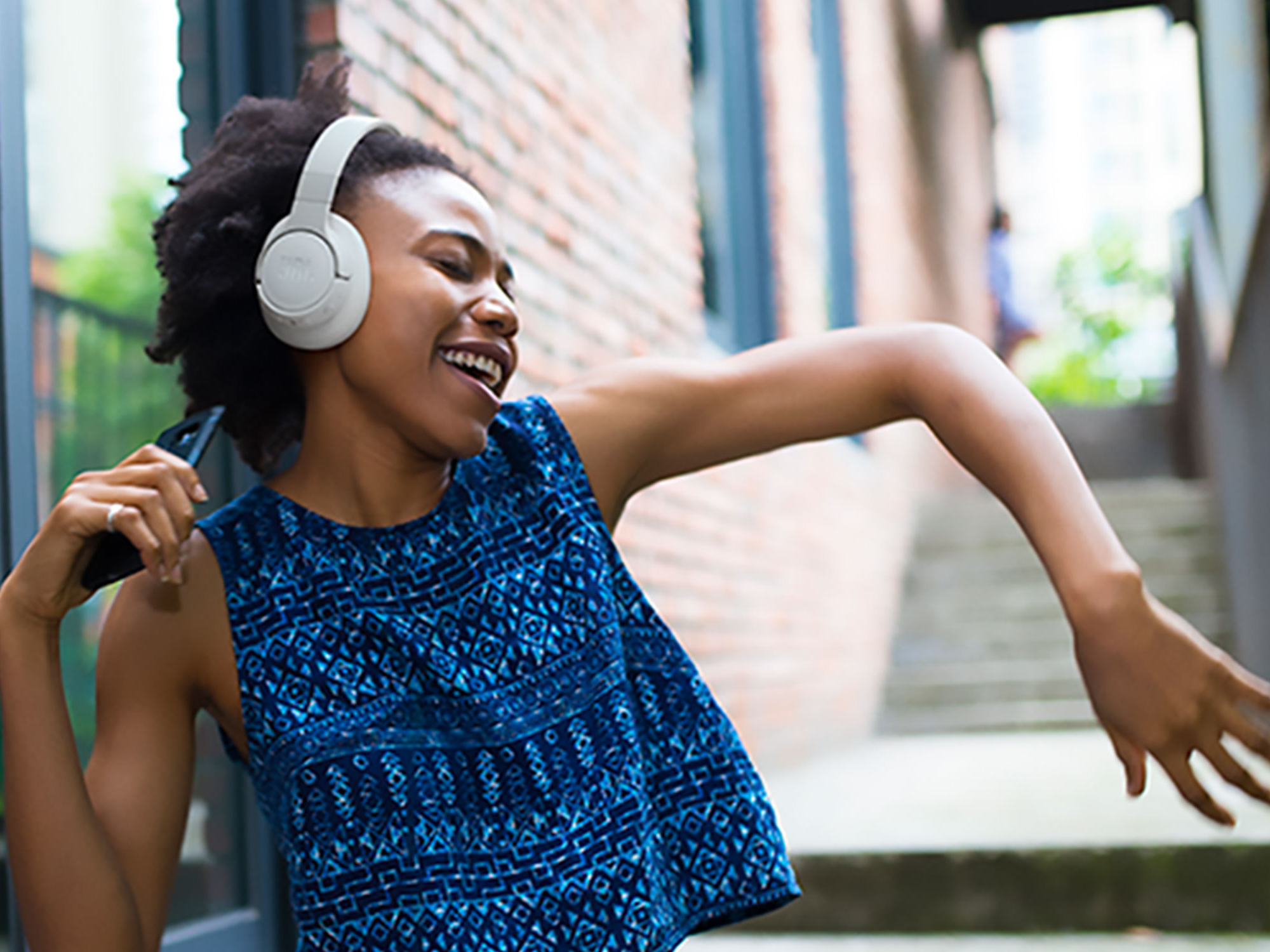 A person listening to music on JBL headphones.