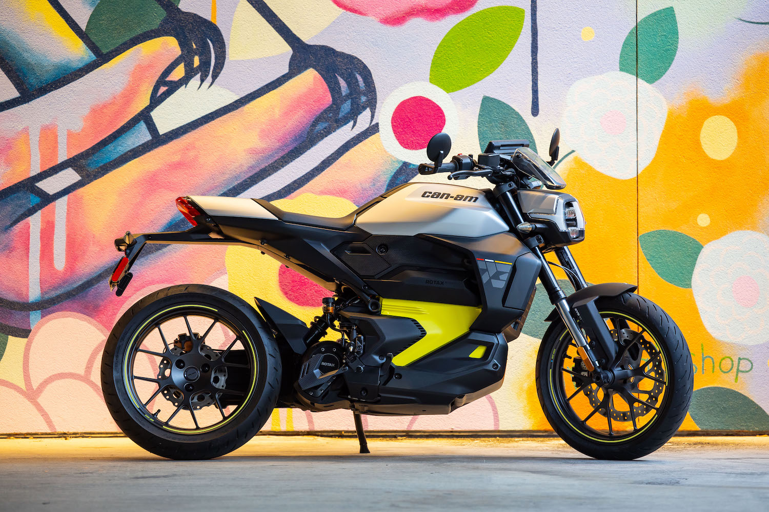 motorcycle in front of art-covered wall