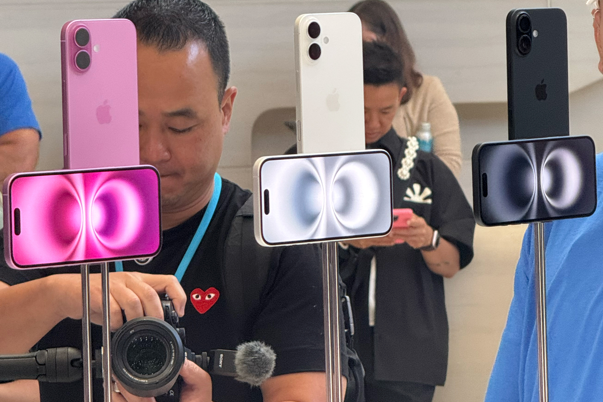 The iPhone 16 on display stands at Apple's headquarters in Cupertino, Calif.