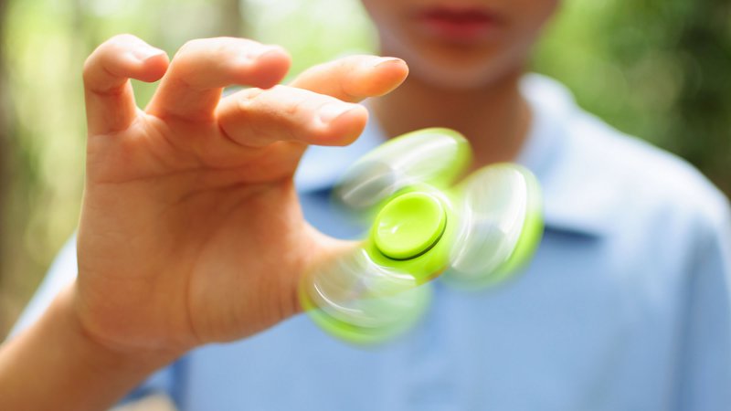 child playing with fidget spinner