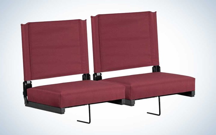  Two portable, padded stadium seats on a plain background.