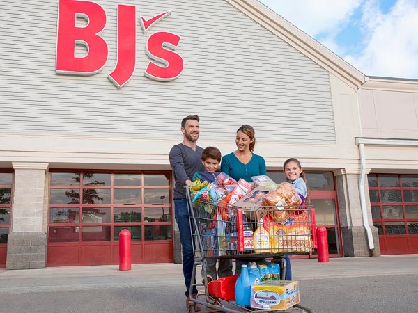 A family leaving out of BJ's with a full cart.