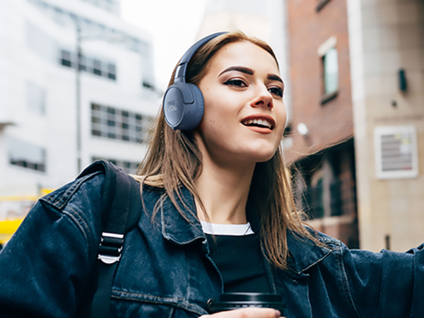 A person wearing JBL noise cancelling headphones