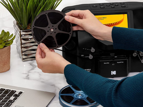 A person digitizing film using a Kodak film digitizer.