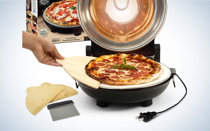  Piezano pizza oven with hand putting pizza on peel