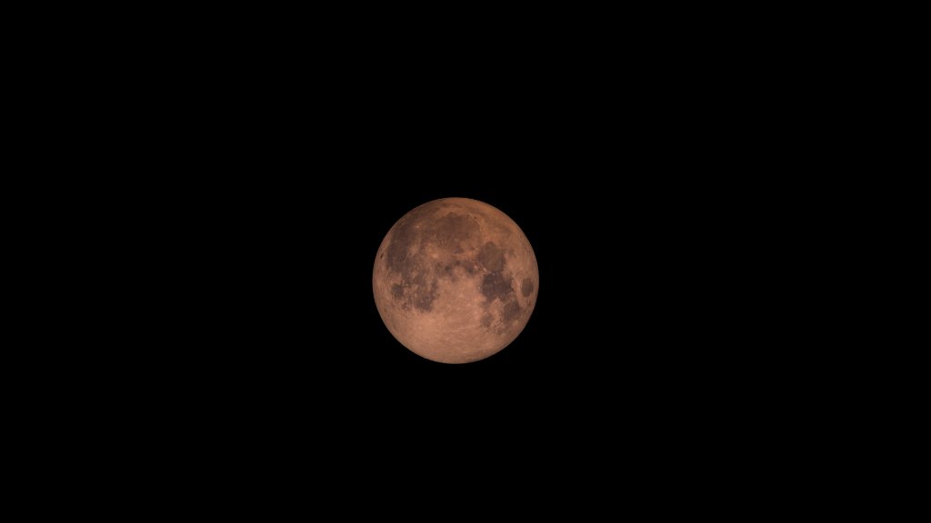 a reddish moon in the sky