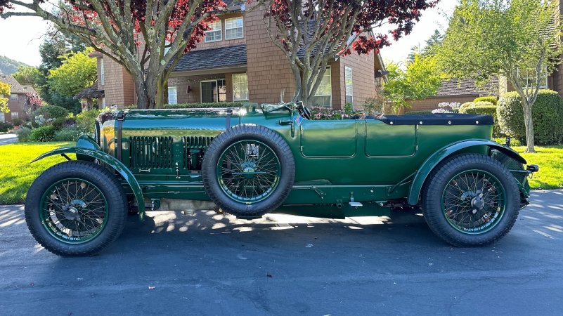 green old car parked on the street