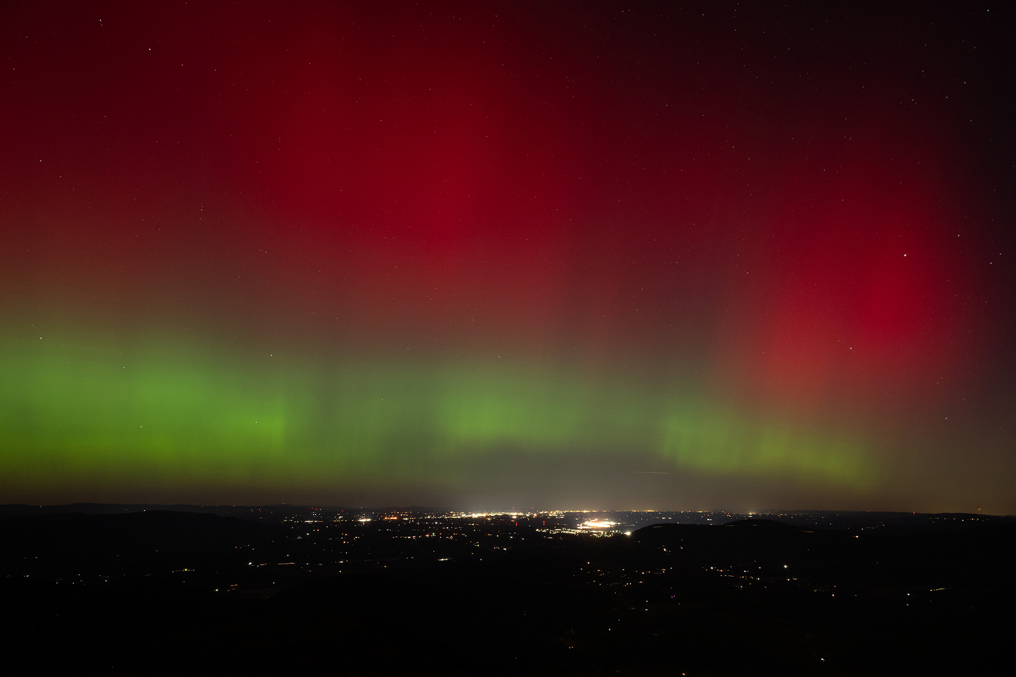 Aurora borealis, or northern lights, produced by a solar geomagnetic storm are seen from Shenandoah National Park in Rileyville, Virginia, on October 10, 2024. A coronal mass ejection from the Sun struck Earth this morning at 11:17 am (1517 GMT), disrupting the Earth's magnetic field and quickly achieving G4 (severe) geomagnetic storm conditions at 12:57 pm, the US Space Weather Prediction Center said. The event is expected to produce auroras potentially as far south as northern California or Alabama. (Photo by SAUL LOEB / AFP) (Photo by SAUL LOEB/AFP via Getty Images)