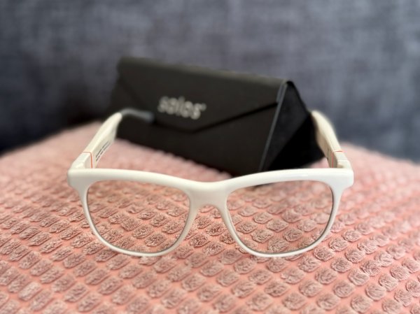 SOLOS AirGo 3 Bluetooth smart glasses on a pink pillow