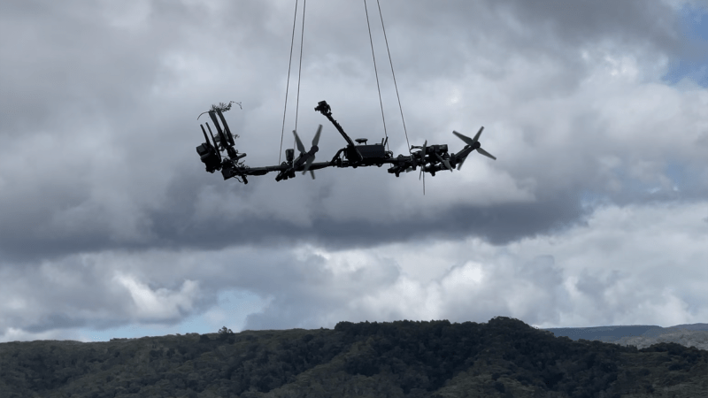 Collecting arm hanging from drone.