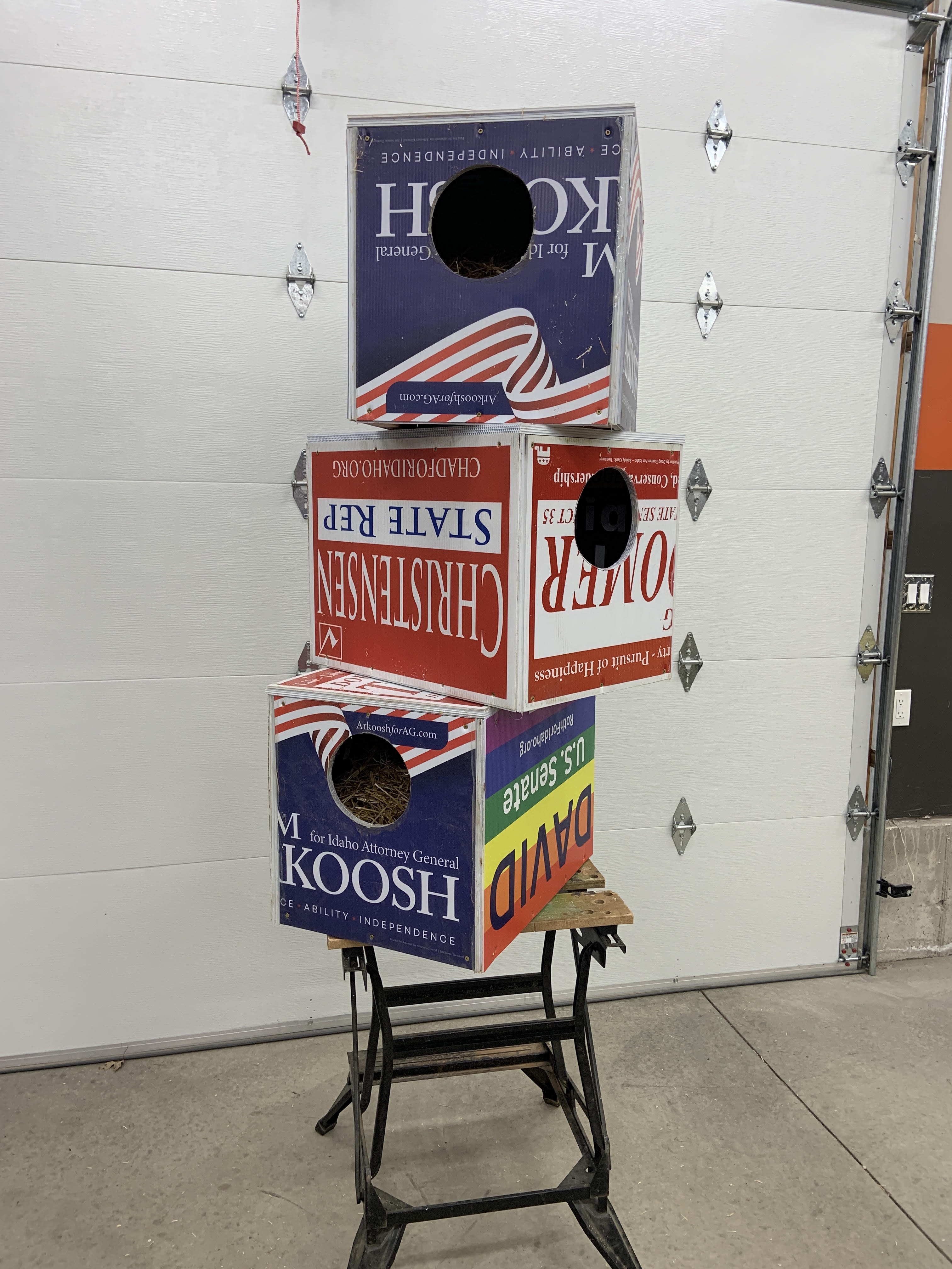 three cat shelters stacked in garage