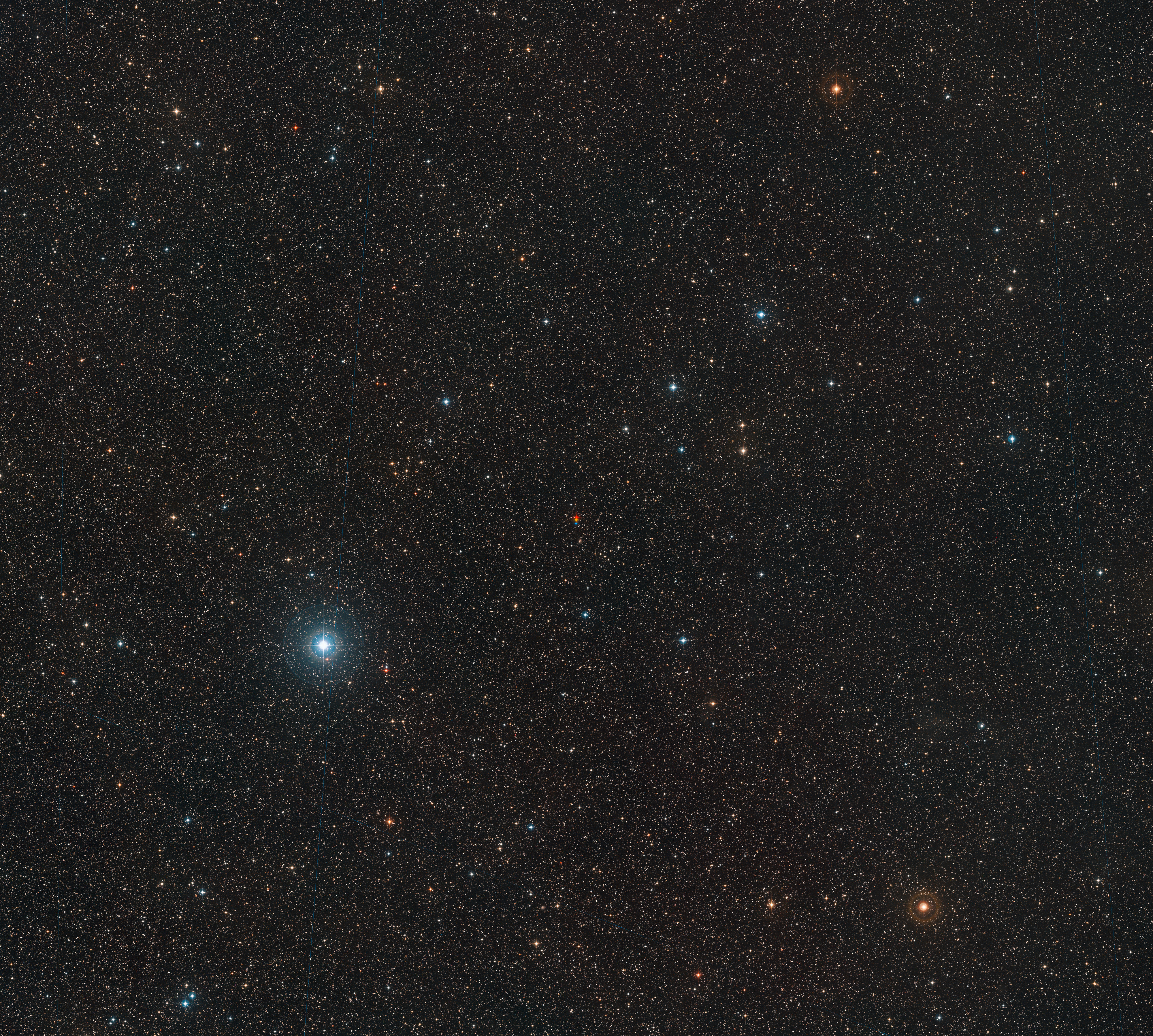 This wide-field image shows the surroundings of the red dwarf known as Barnard’s Star in the constellation of Ophiuchus (the Serpent-Bearer). This picture was created from material forming part of the Digitized Sky Survey 2. The centre of the image shows Barnard’s Star captured in three different exposures. The star is the fastest moving star in the night sky and its large apparent motion can be seen as its position changes between successive observations — shown in red, yellow and blue.