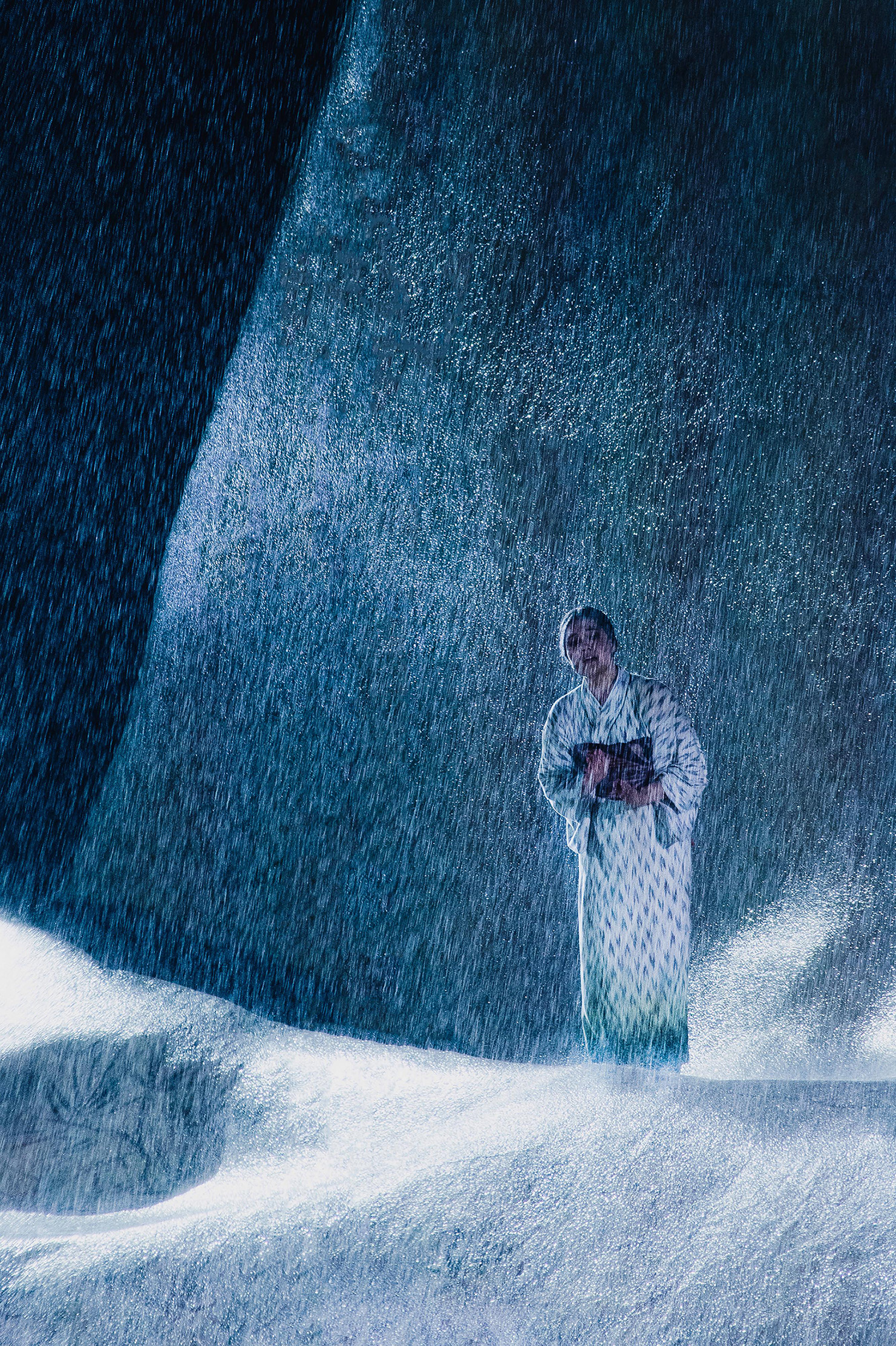 a woman in a kimono stands in the rain