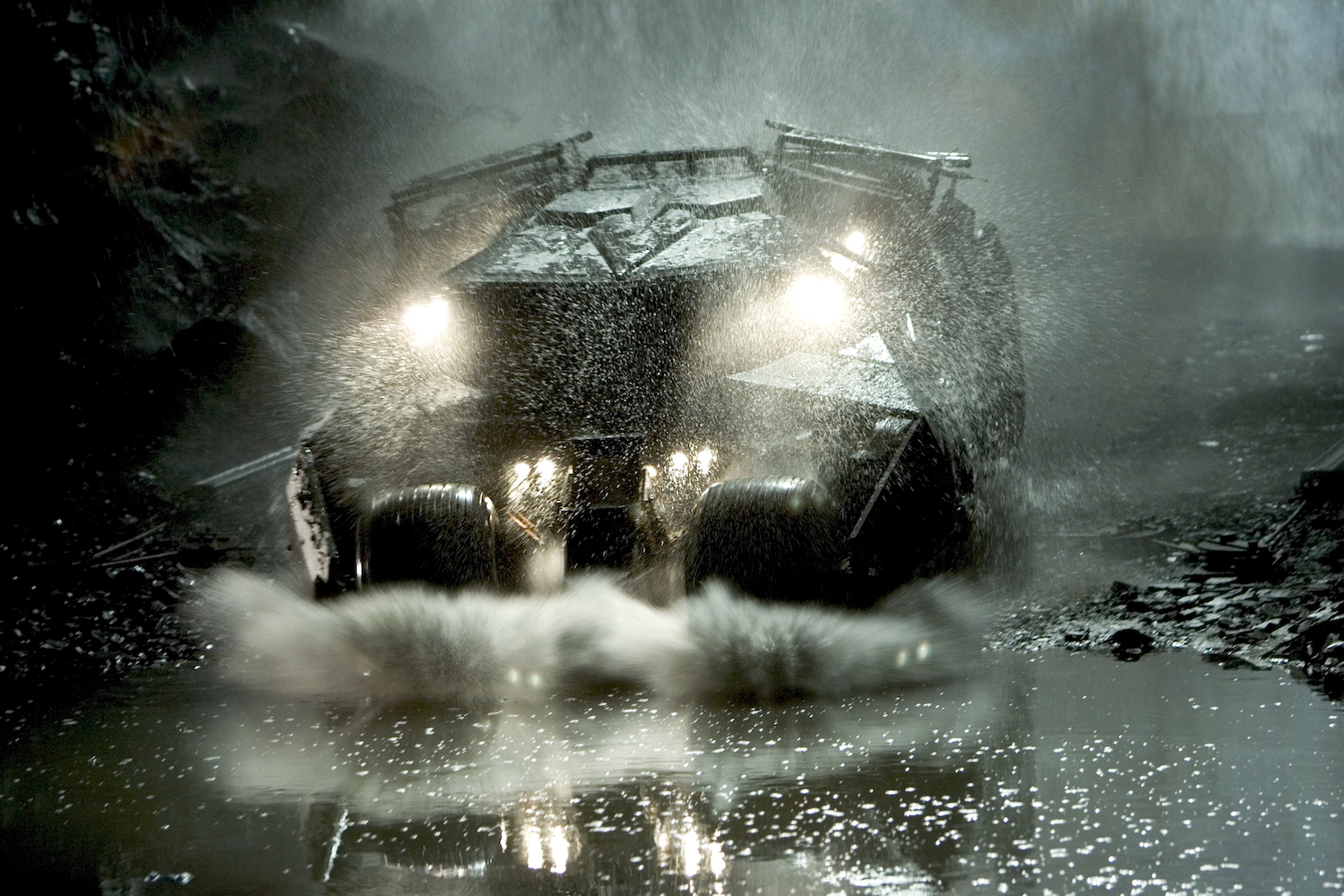 car driving through puddle at night