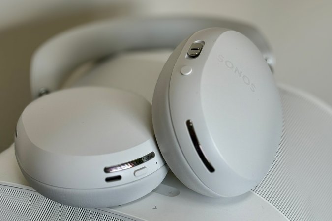  White Sonos Ace headphones sitting on top of a white Sonos Era 300 speaker