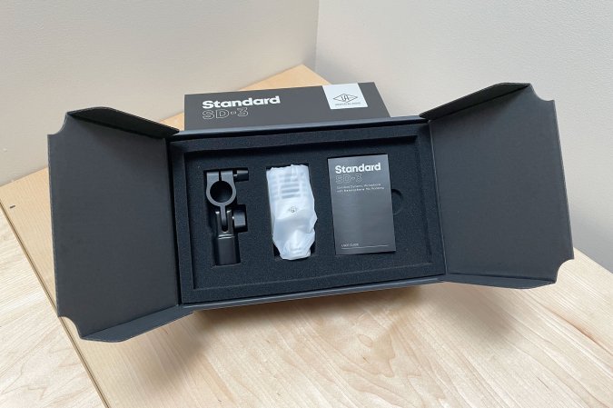  The UA Standard Series mic with accessories sitting in its open packaging