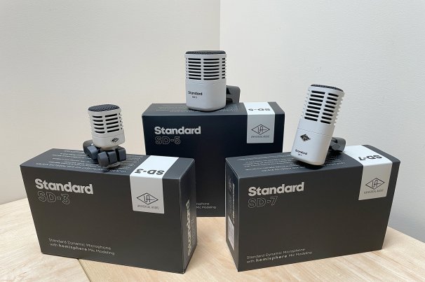 Three Universal Standard Series drum mics sitting on top of their boxes