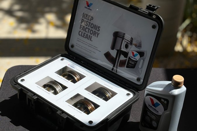 A display case in the Napa, California sun shows off four pistons of increasing cleanliness to illustrate the effect Valvoline Restore & Protect engine oil can have on high-mileage vehicles after regularly scheduled maintenance