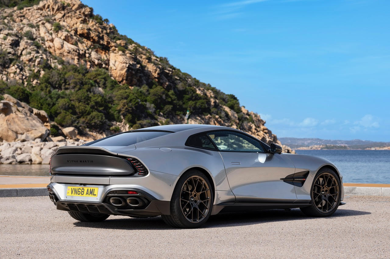 a silver sports car parked by the sea