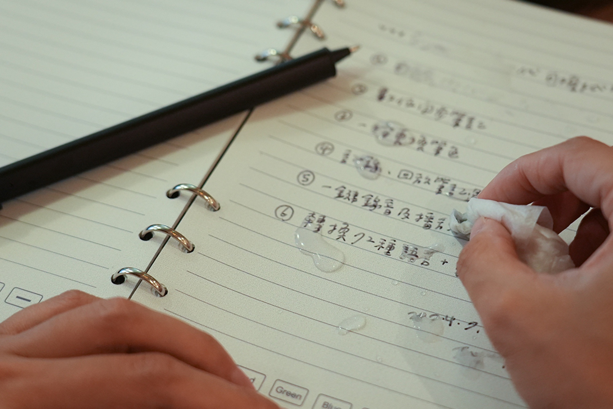 a person using a smart pen with erasable ink.