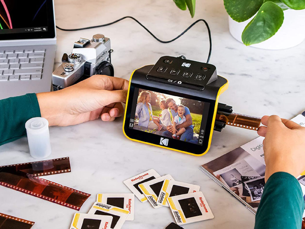 A person digitizing photos using the Kodak Slide n Scan