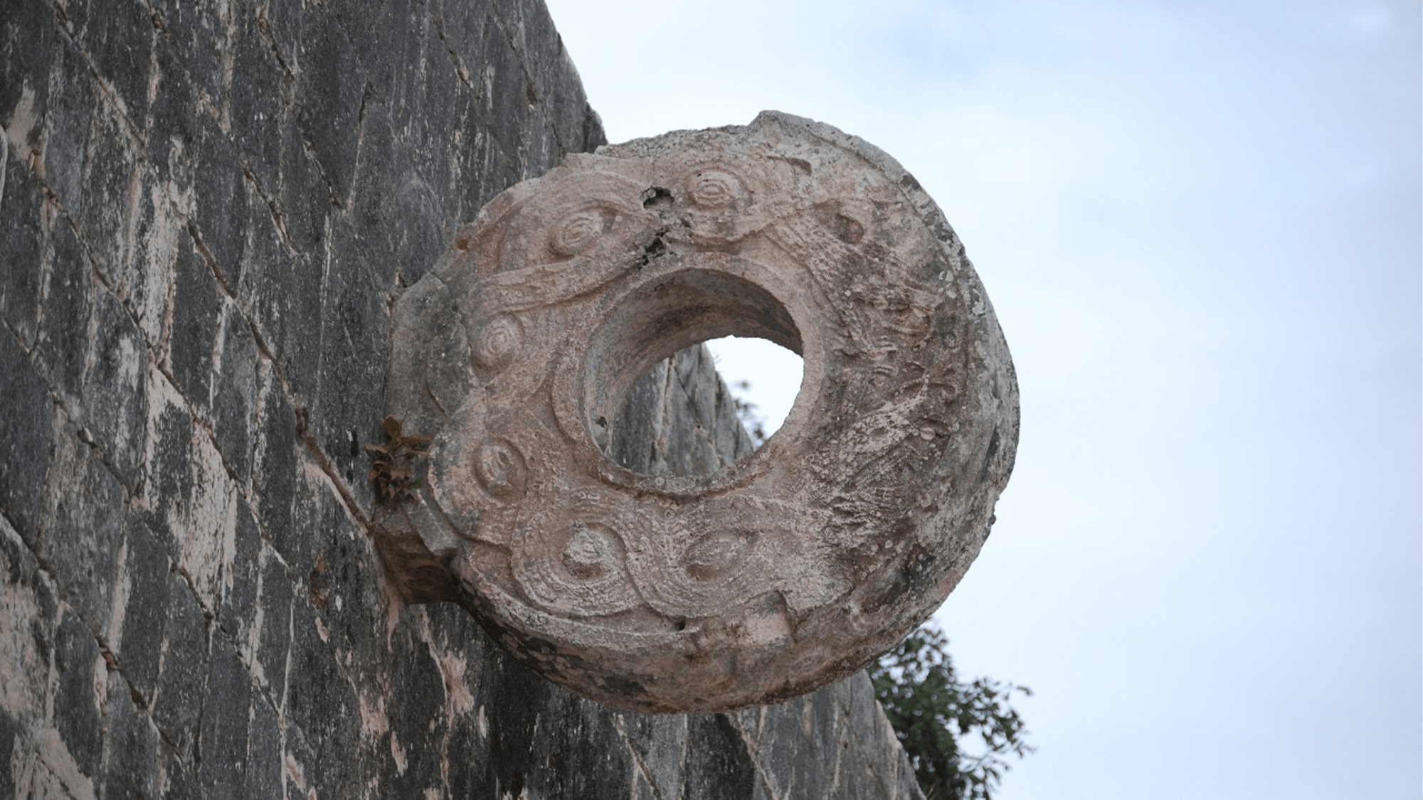 
A decorative ring made from carved stone is embedded in the wall of a ballcourt in the ancient Maya city of Chichen Itza in present day Mexico. CREDIT: LanaCanada.
