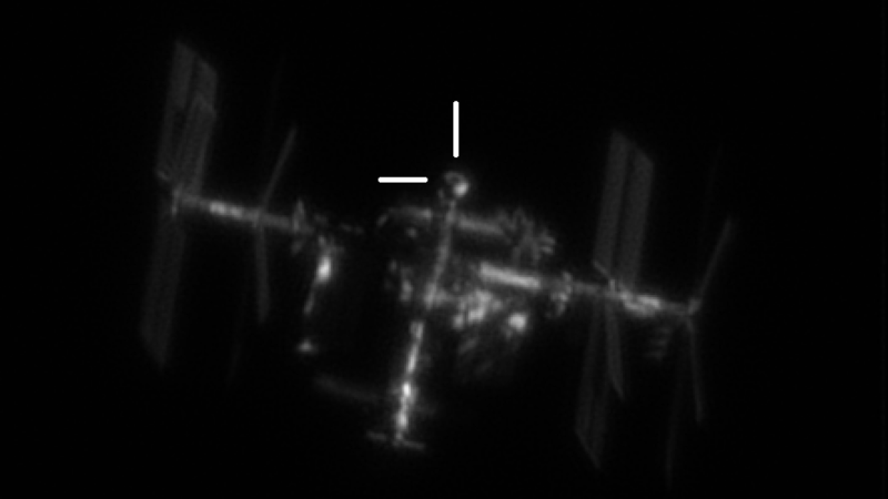 ISS with lines pointing to docked Starliner spacecraft