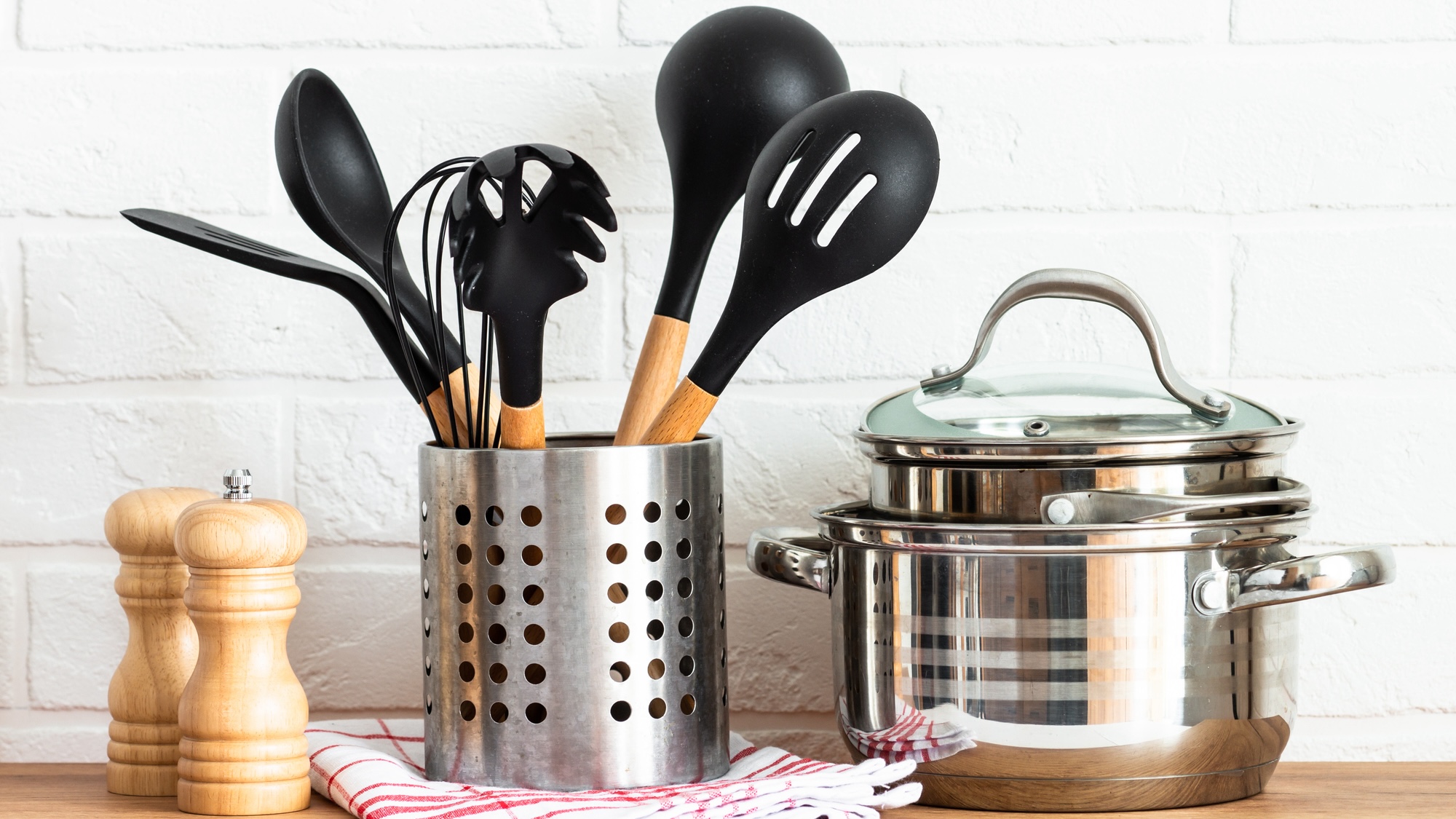 Modern Kitchen with wooden table, kitchen utensils, cooking pots and others, white background.