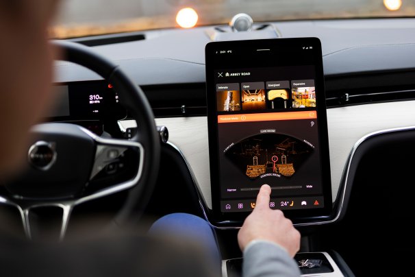 A participant in the Volvo x Bowers & Wilkins Abbey Road Studio Mode launch experiments with the interface in an EX90 EV SUV.