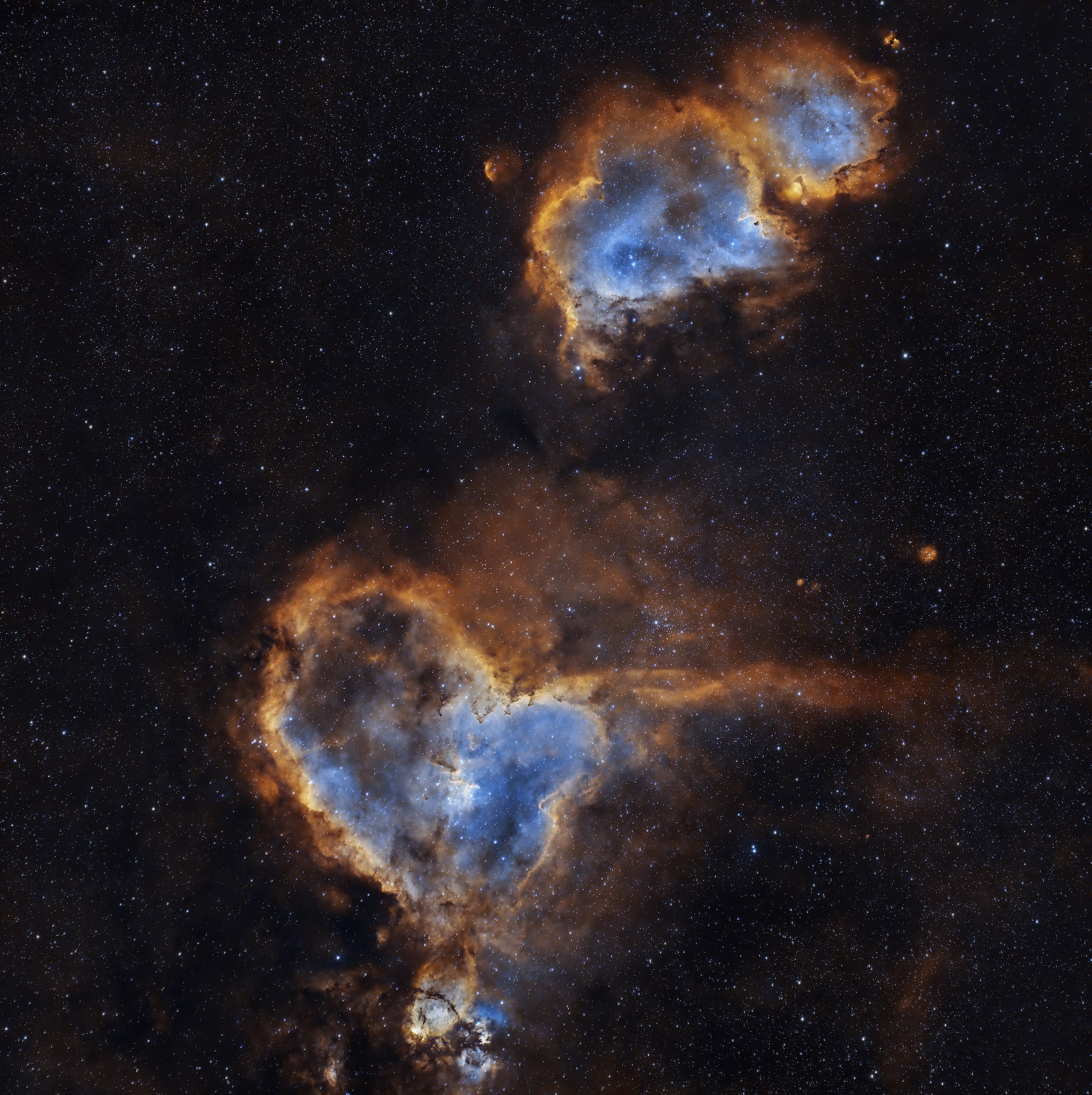 two blue bubbles of color against a black and star-filled sky