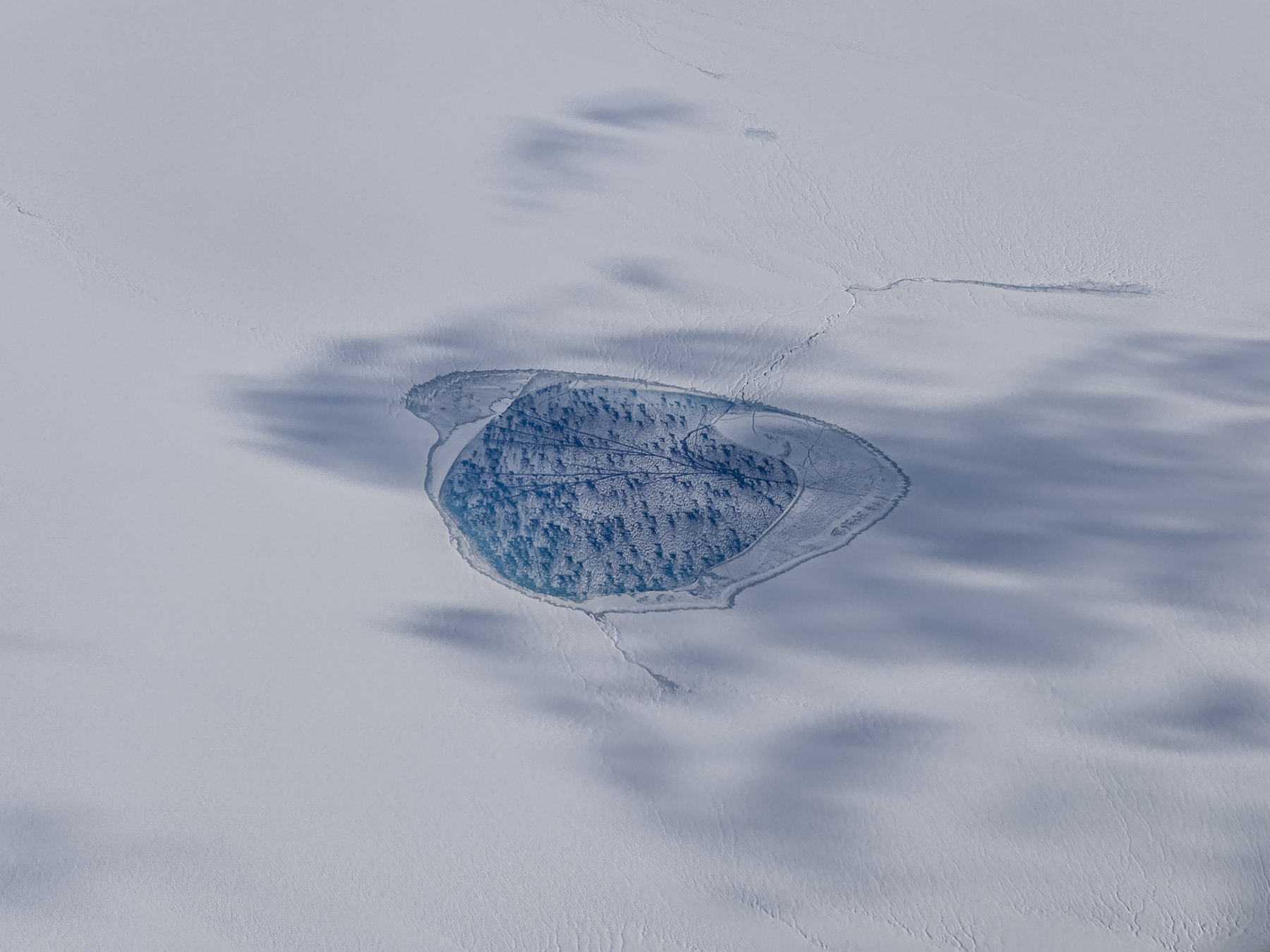 a circular break in the surface of white ice