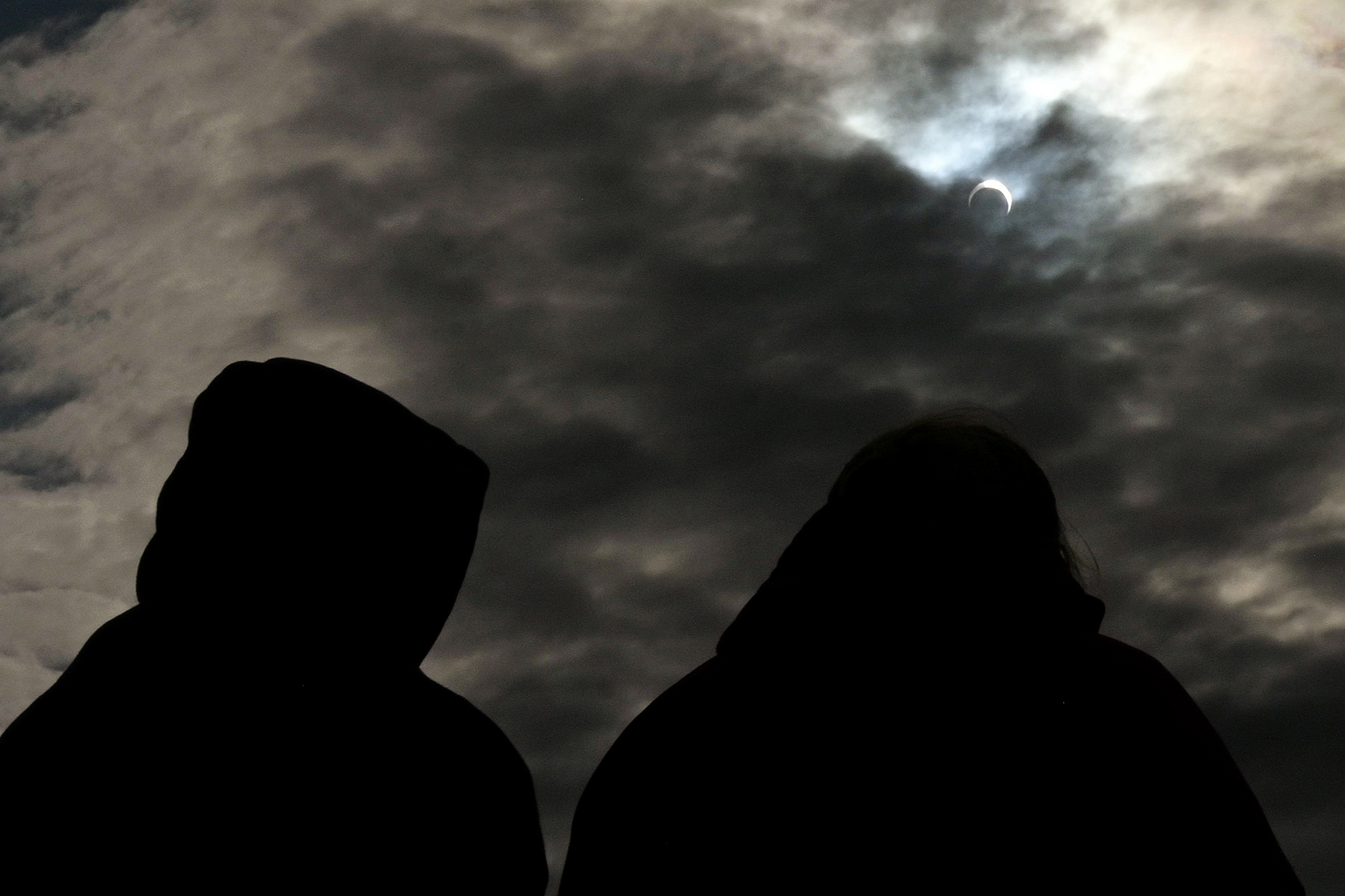 Astronomy enthusiast look at the partial view of the solar annular eclipse eclipse in Puerto San Julian, Santa Cruz province, Argentina on October 2, 2024. (Photo by Juan MABROMATA / AFP) (Photo by JUAN MABROMATA/AFP via Getty Images)