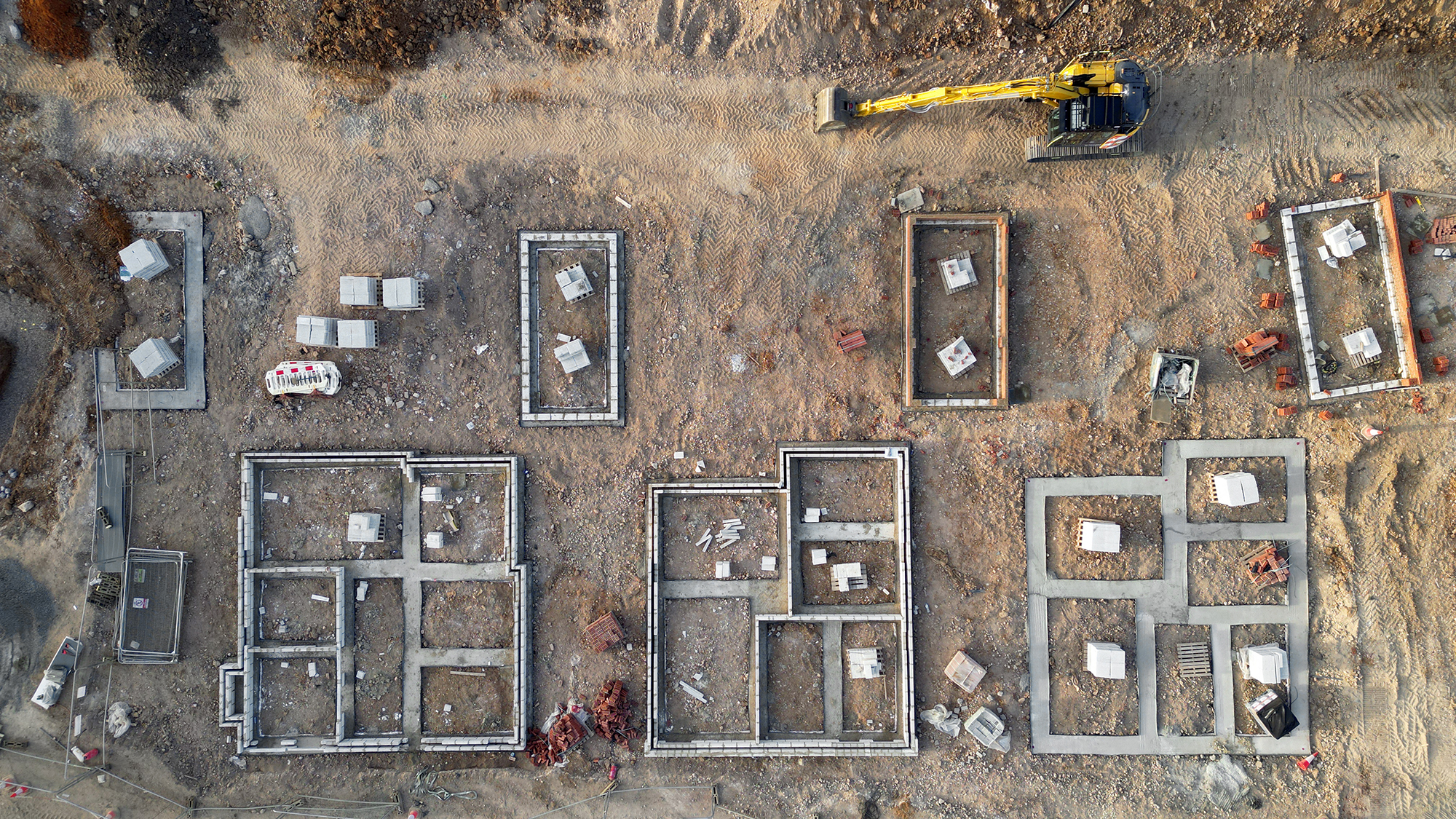 Aerial view of house foundations being constructed.