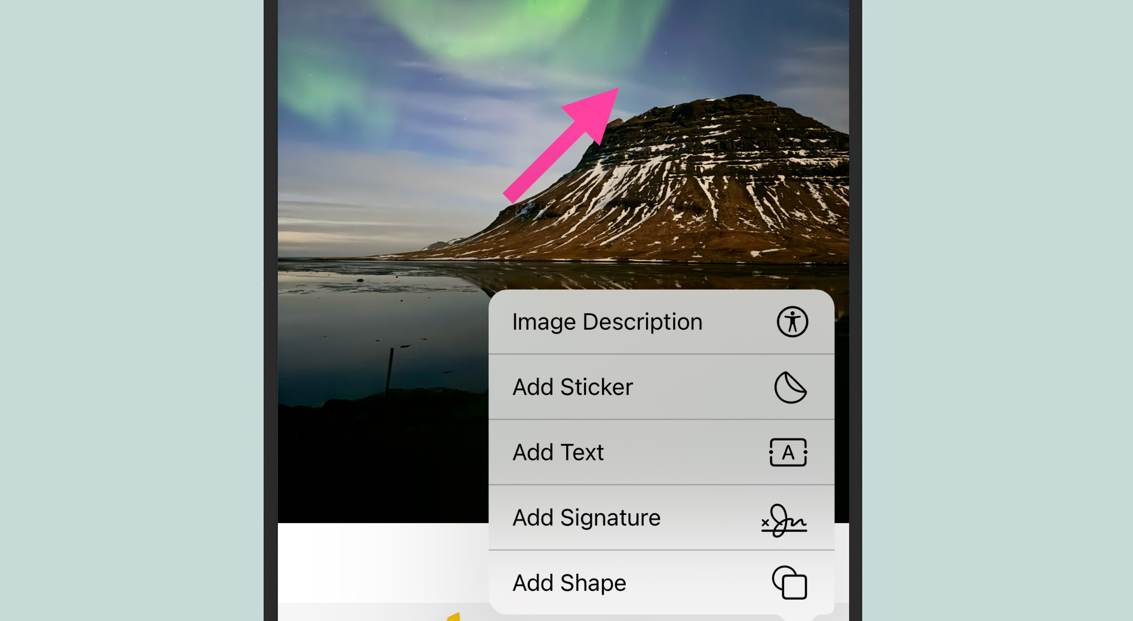 screenshot of an iphone photo of northern lights in iceland with a pink arrow added on top