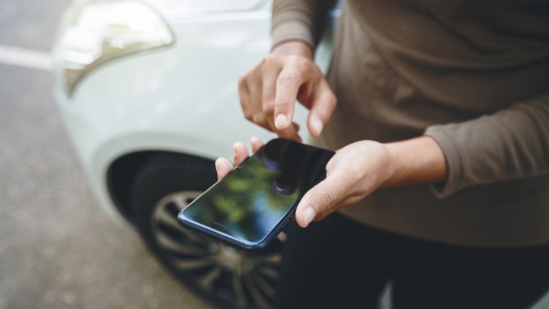 person using phone on road