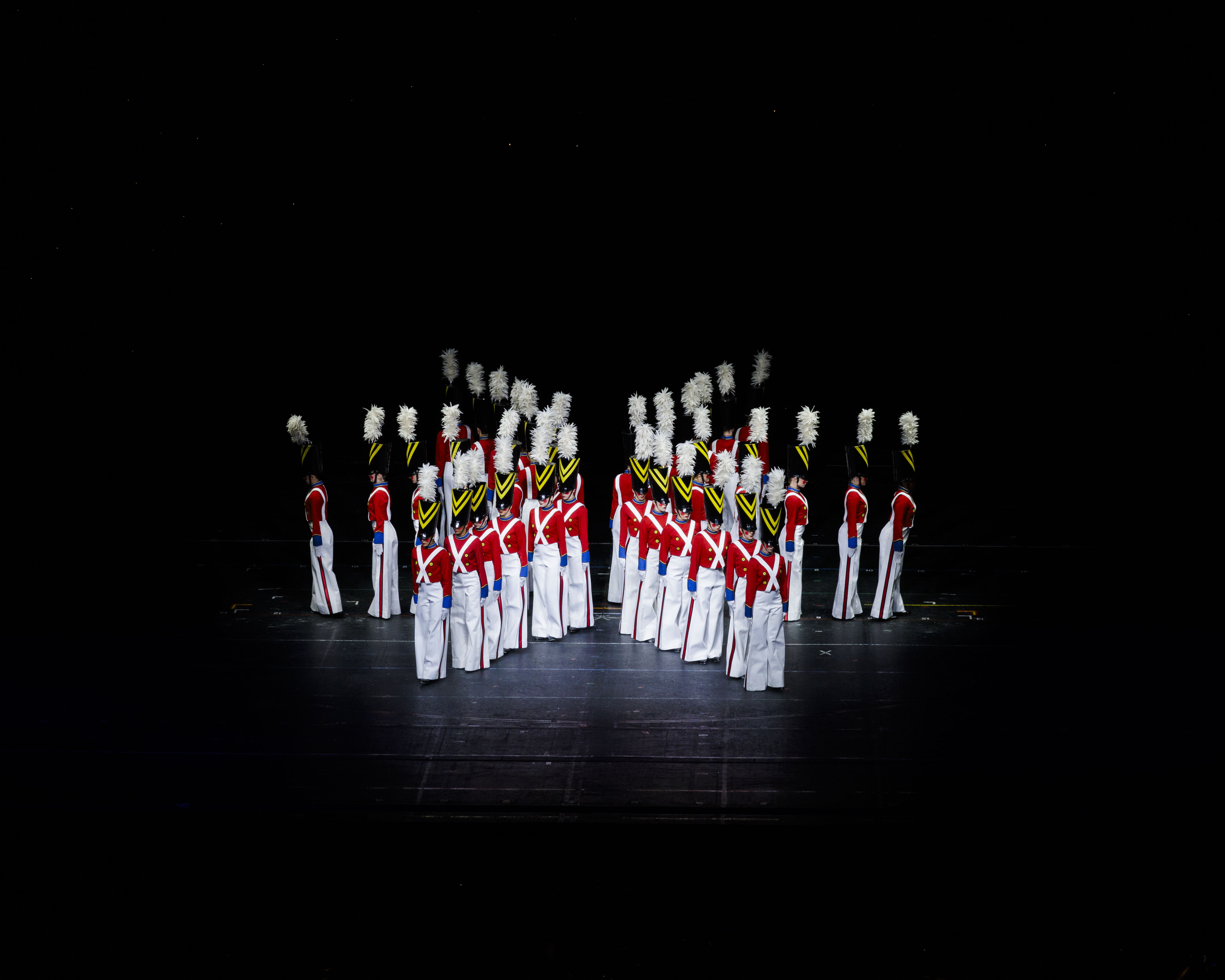 a dress rehaersal photo of the rockettes dressed as wooden soldiers standing in a pinwheel shape