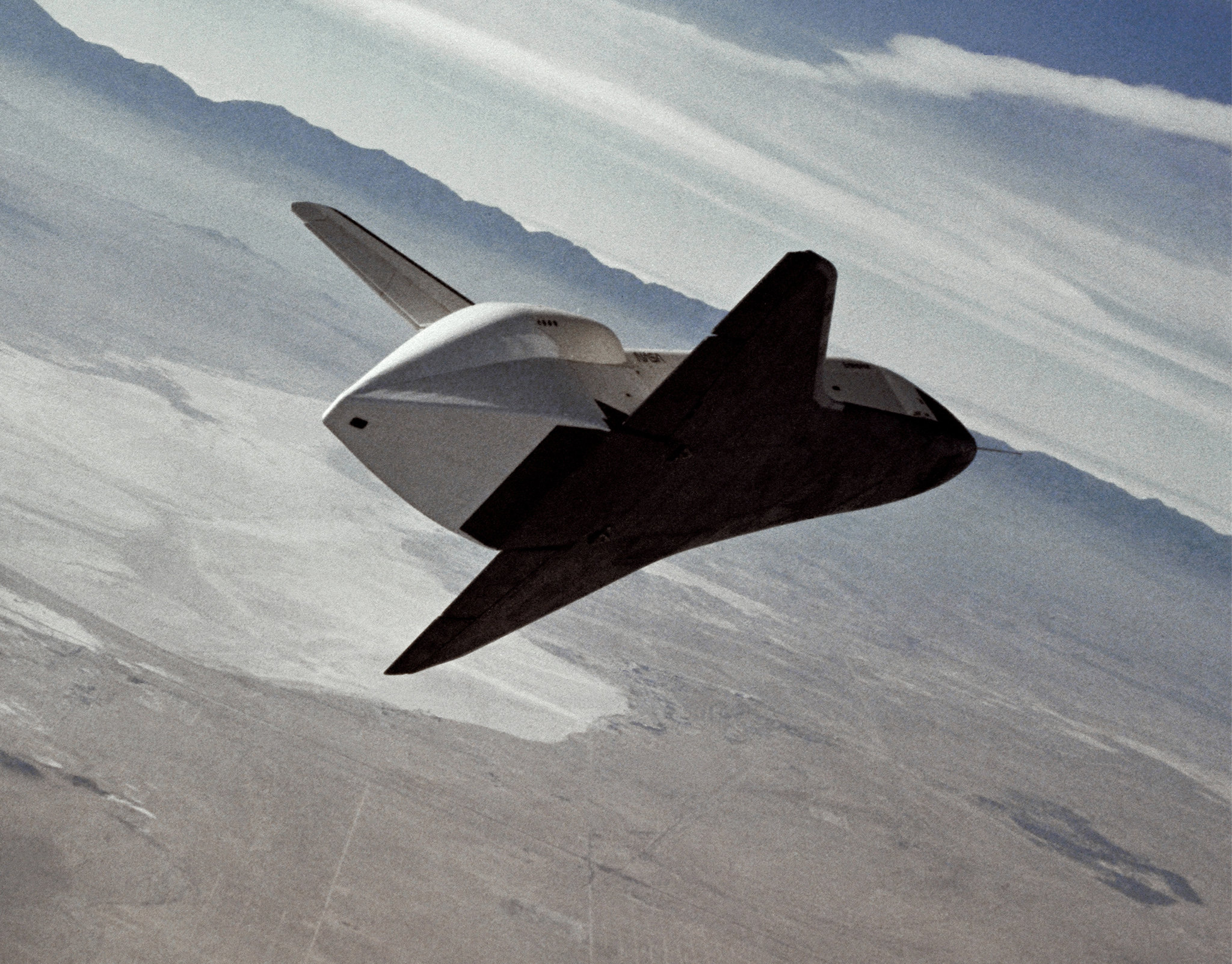 a space shuttle flying above the desert