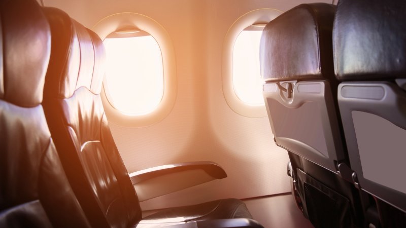 Interior of plane cabin with sunlight coming in from window