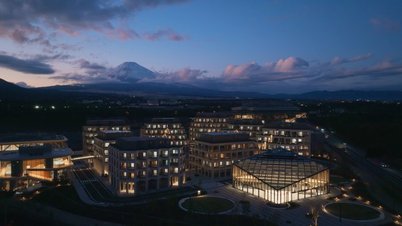 Toyota's Woven City at dusk with Mount Fuji in background