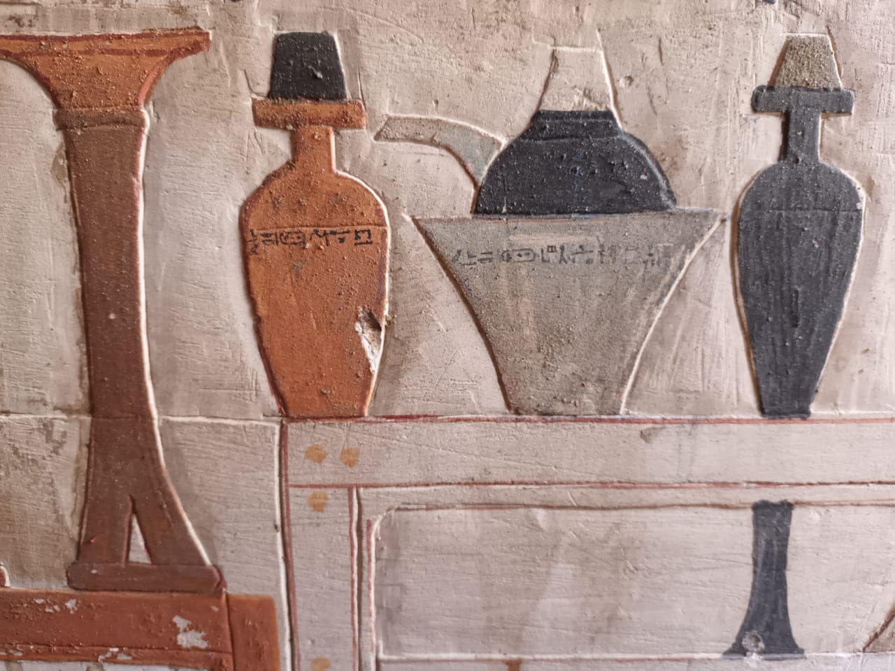 etchings on a tomb from ancient egypt. it shows four vessels of various sizes