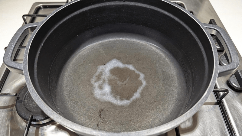 a white ring of salt at the bottom of a black pan