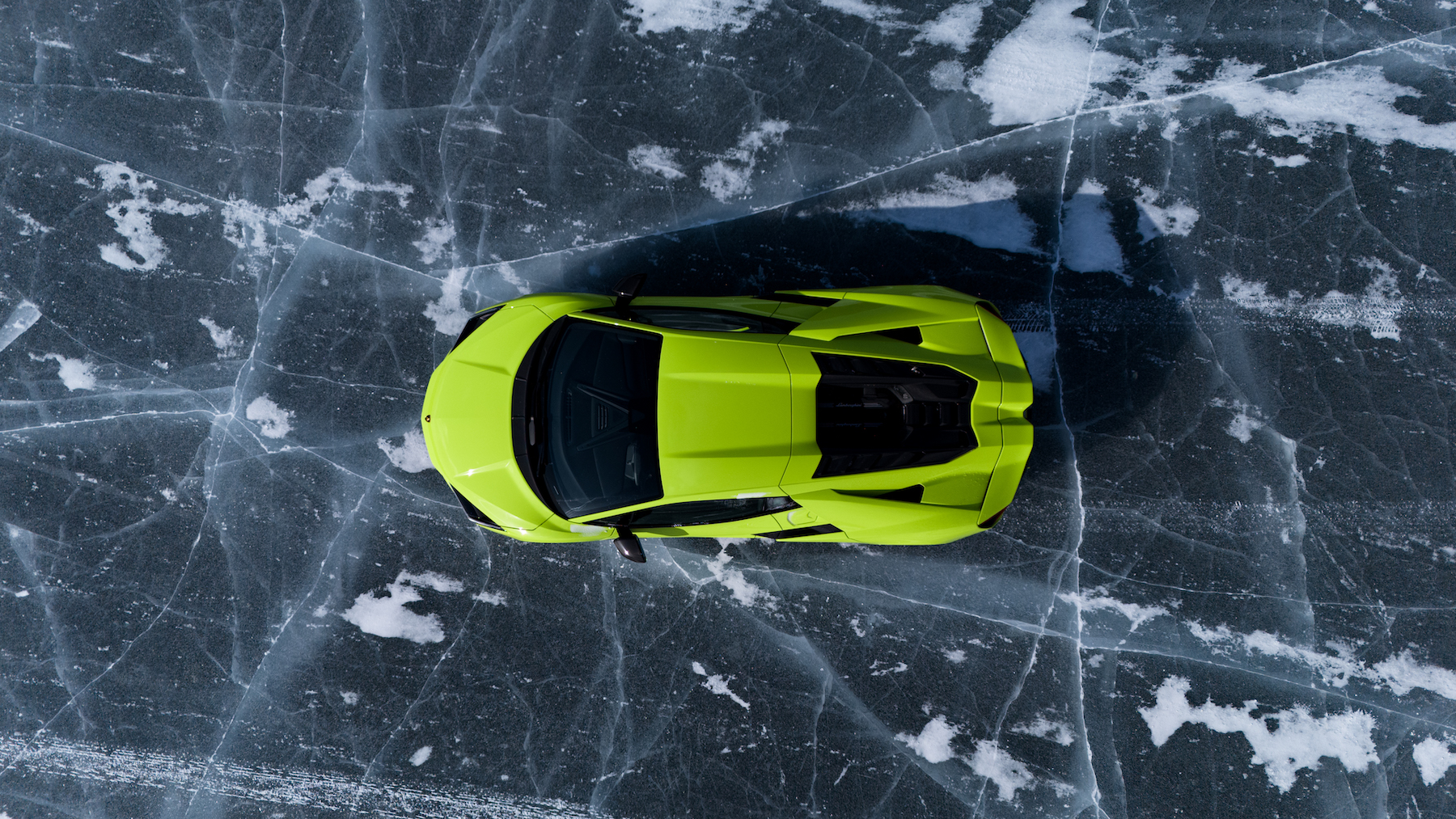 a sports car driving on ice, pictured from above